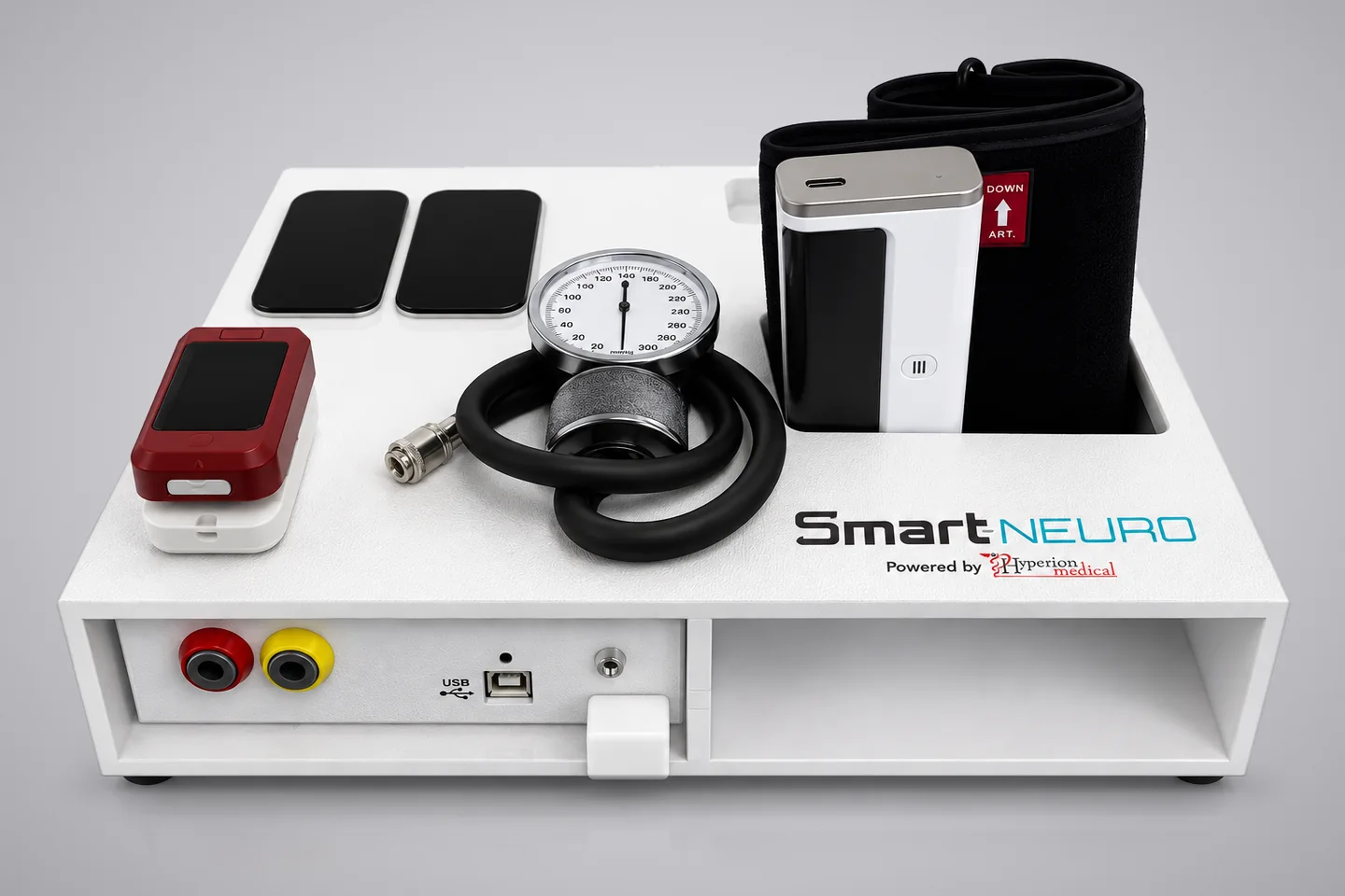 Smart-Neuro device tray holding a blood pressure cuff, pressure gauge, pulse oximeter, and two electrode pads